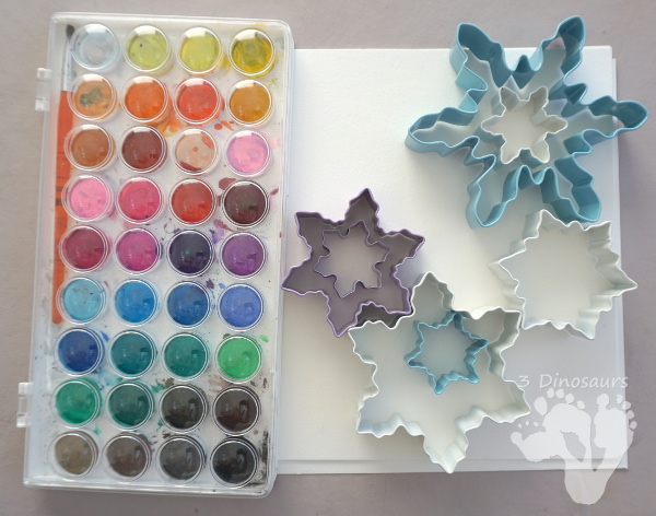 Fun to Make Watercolor Snowflakes - make fun snowflake themed painting using cookies cutters - 3Dinosaurs.com #watercolorforkids #cookiecuttes #paintingforkids #finemotorskills #winteractivitiesforkids