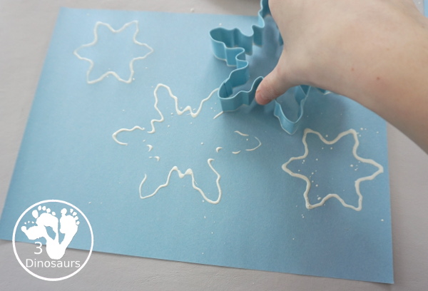 Making Snowflakes - Snowflake Cookie Cutter Painting - a simple painting craft that different ages of kids can do - 3Dinosaurs.com
