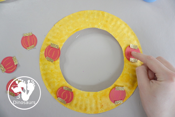 Lunar New Year Wreath Craft for kids - a simple paper plate wreath you can make with kids for the lunar new year and Chinese New year with a red lantern theme - 3Dinosaurs.com