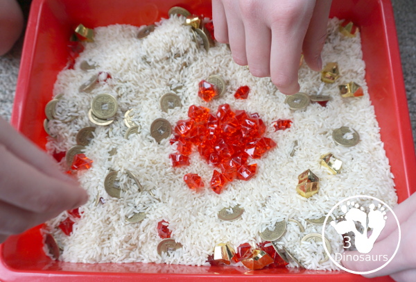 Lunar New Year Sensory Bin - a fun sensory bin with rice, coins, and red rocks for a simple and easy to put together sensory bin for Chinese New year or Lunar New Year- 3Dinosaurs.com