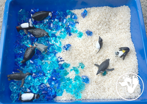 Penguin Rice Sensory Bin - with penguins, blue acrylic rocks and rice for a fun polar animal sensory bin that kids can play in. - 3Dinosaurs.com