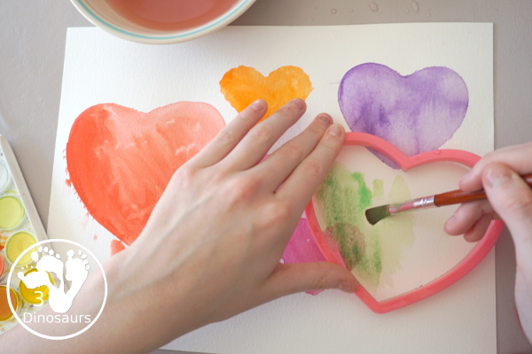 Watercolor Hearts Painting For Kids - a fun painting activity using watercolor and cookie cutters to make a really fun painting for Valentines - 3Dinosaurs.com