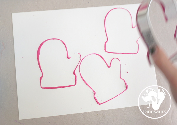 Mitten Cookie Cutter Stamp Painting - a simple winter painting that kids can do with a mitten cookie cutter. - 3Dinosaurs.com