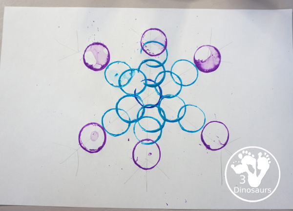 Paper Roll Painted Snowflake - a fun snowflake painting with blue and purple colors and using paper rolls to make the snowflakes. A simple and easy PreK and kindergarten craft for winter. - 3Dinosaurs.com