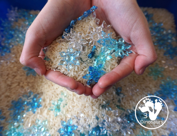 Snowflake Sensory Bin with Rice Filler - a simple sensory bin with rice for the filler and three colors of acrylic snowflakes in the sensory bin. Only a minute to set up this sensory bin. - 3Dinosaurs.com