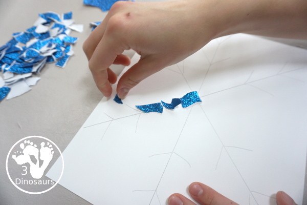 Torn Paper Glitter Snowflake Craft - a fun torn paper craft to make snowflakes out of glitter paper a fun winter craft for kids. - 3Dinosaurs.com