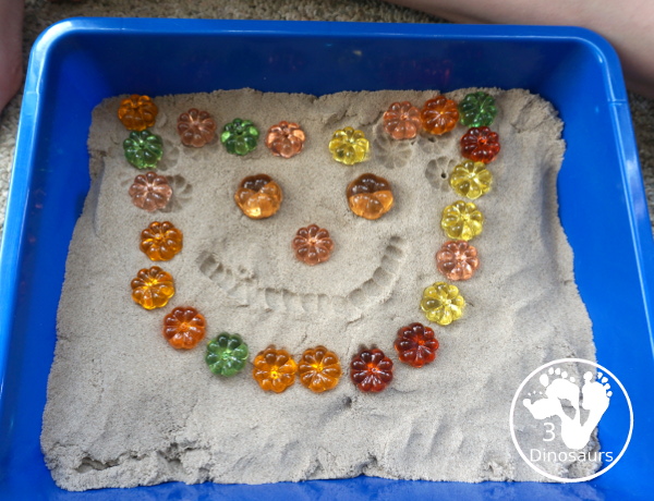 Pumpkin & Kinetic Sand Sensory Bin - a simple and easy fall sensory bin with pumpkins and kinetic sand for kids to play in. - 3Dinosaurs.com