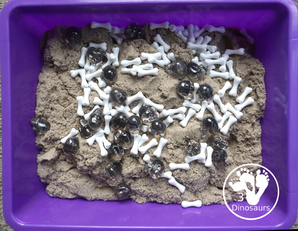 Bone Sensory Bin for Halloween - a fun kinetic sand sensory bin with a bone theme for Halloween - 3Dinosaurs.com