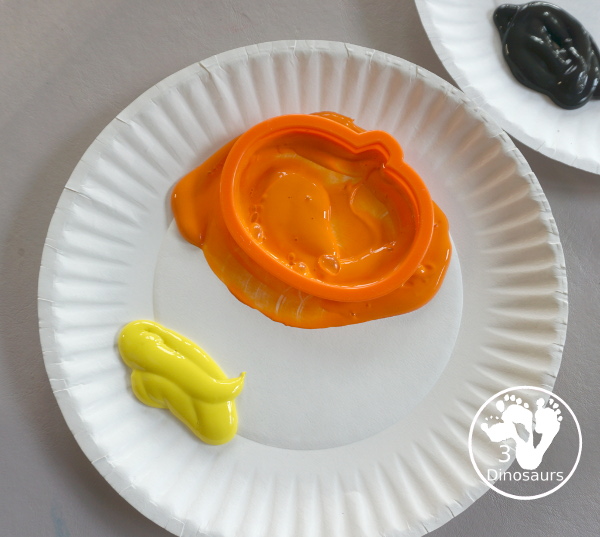 Halloween Stamping With Cookie Cutters - painting with cookie cutters using them to stamp paint with the cookie cutters on a piece of paper. A great tot, preschool and prek painting activity - 3Dinosaurs.com