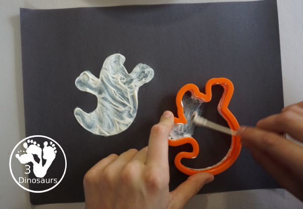 Ghost Painting with Cookie Cutters - a super simple painting inside ghost cookie cutters with white paint and black paper - 3Dinosaurs.com