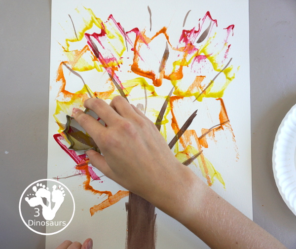 Fall Tree Scrape Painting with Leaf Cookie Cutters - a simple watercolor trunk and branches with leaf cookie cutter scrape painting. A great fall tree craft for kids.  3Dinosaurs.com