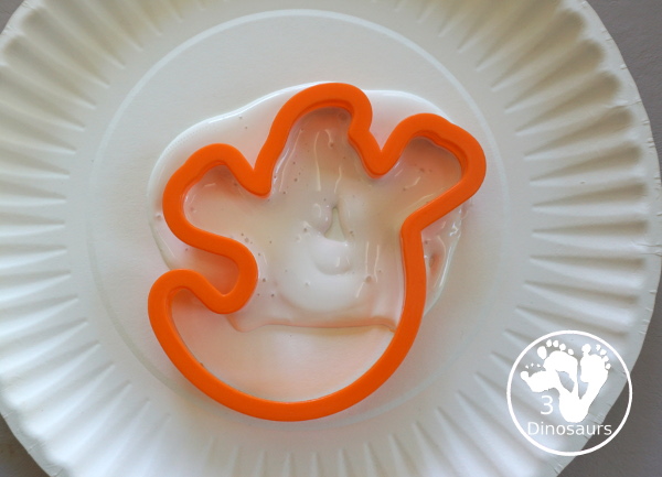 Ghost Scrape Painting with Cookie Cutters - a simple painting activity for kids with paint and ghost cookie cutters that different ages can make together for Halloween. - 3Dinosaurs.com