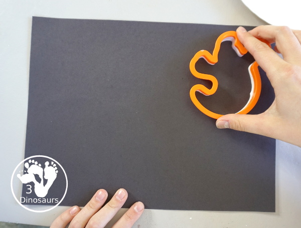 Ghost Scrape Painting with Cookie Cutters - a simple painting activity for kids with paint and ghost cookie cutters that different ages can make together for Halloween. - 3Dinosaurs.com
