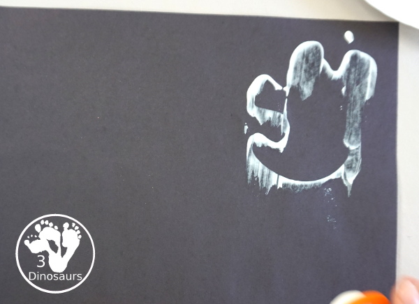 Ghost Scrape Painting with Cookie Cutters - a simple painting activity for kids with paint and ghost cookie cutters that different ages can make together for Halloween. - 3Dinosaurs.com