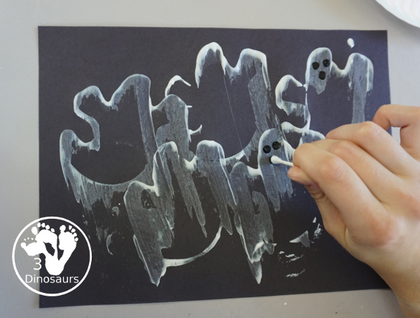 Ghost Scrape Painting with Cookie Cutters - a simple painting activity for kids with paint and ghost cookie cutters that different ages can make together for Halloween. - 3Dinosaurs.com