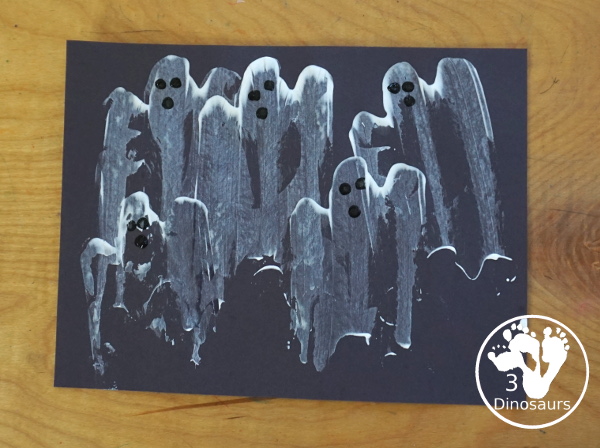 Ghost Scrape Painting with Cookie Cutters - a simple painting activity for kids with paint and ghost cookie cutters that different ages can make together for Halloween. - 3Dinosaurs.com
