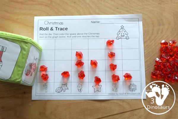 Christmas Roll & Graph With Trace Letters, Numbers & Shapes with a folding die and cube die with a graphing sheet, graphing with tracing numbers, graphing with tracing letters and graphing with tracing shapes. All with a fun holiday theme for Christmas for prek and kindergarten - 3Dinosaurs.com