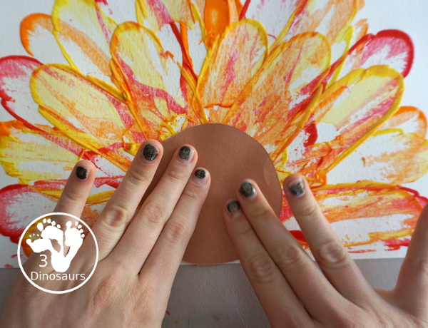 Turkey Feather Scrap Painting for Kids - a fun turkey craft made with a cookie cutter feather and construction paper. A fun painting idea with feathers for a Thanksgiving craft for kids in preschool, prek, and kindergarten. 3Dinosaurs.com