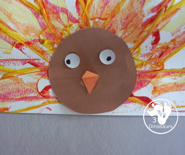 Turkey Feather Scrap Painting for Kids - a fun turkey craft made with a cookie cutter feather and construction paper. A fun painting idea with feathers for a Thanksgiving craft for kids in preschool, prek, and kindergarten. 3Dinosaurs.com
