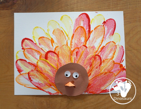 Turkey Feather Scrap Painting for Kids - a fun turkey craft made with a cookie cutter feather and construction paper. A fun painting idea with feathers for a Thanksgiving craft for kids in preschool, prek, and kindergarten. 3Dinosaurs.com