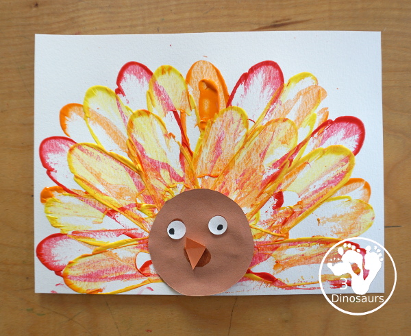 Turkey Feather Scrap Painting for Kids - a fun turkey craft made with a cookie cutter feather and construction paper. A fun painting idea with feathers for a Thanksgiving craft for kids in preschool, prek, and kindergarten. 3Dinosaurs.com