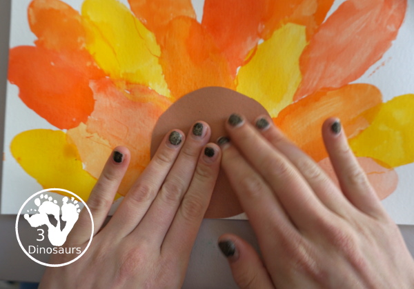 Turkey Feather Watercolor Painting for Kids - a fun turkey craft made with a cookie cutter feather and construction paper. A fun watercolor painting idea with feathers for a Thanksgiving craft for kids in preschool, prek, and kindergarten. 3Dinosaurs.co