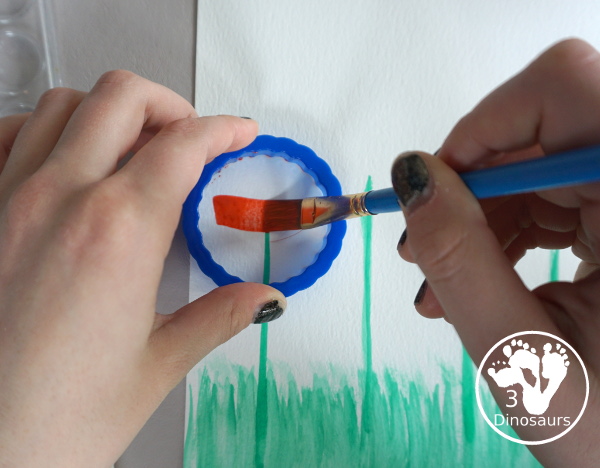 Watercolor Poppy Painting For Veteran's Day - a fun  watercolor painting using cookie cutters for the circle flowers and q-tip painting for the center. Simple and easy to do with kids. - 3Dinosaurs.com