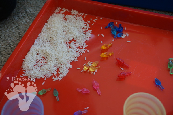 Christmas Lights & Rice Sensory Bin - simple and easy to set up sensor bin for kids to play in and great for sensory play - 3Dinosaurs.com