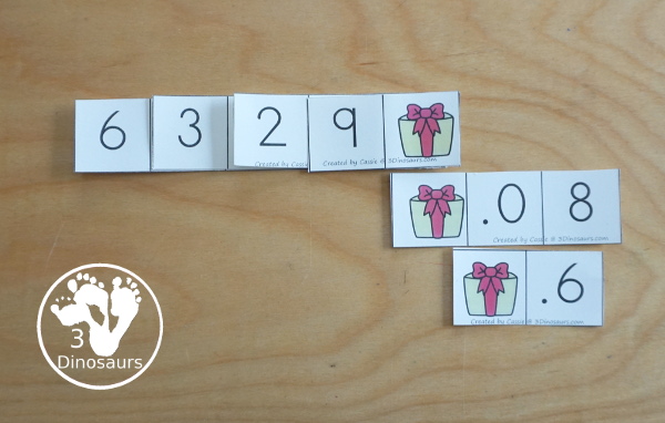 Free Christmas Themed Place Value Arrow Cards - work on building numbers from 0 to 9999 or 9999.99 to 0.99 with these Christmas Themed arrow cards. Plus use task cards to build the numbers. - 3Dinosaurs.com