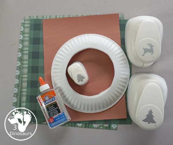 Reindeer Christmas Wreath Craft - a super easy wreath made with reindeer punches and tree punches that kids can make - 3Dinosaurs.com