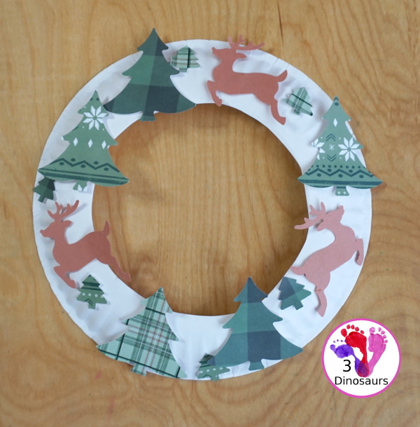 Reindeer Christmas Wreath Craft - a super easy wreath made with reindeer punches and tree punches that kids can make - 3Dinosaurs.com