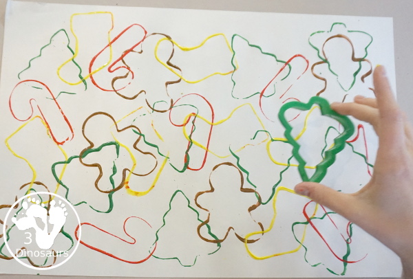 Christmas Cookie Cutter Painting - You stamp cookie cutters on the paper with each cookie cutter having a different color - 3Dinosaurs.com