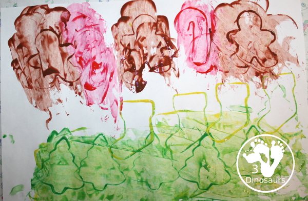 Christmas Cookie Cutter Painting - You stamp cookie cutters on the paper with each cookie cutter having a different color - 3Dinosaurs.com