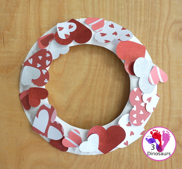 Valentines Heart Wreaths with Scrapbook Paper a fun paper plate wreath made using a heart punch and loads of fun for Valentines Day - 3Dinosaurs.com