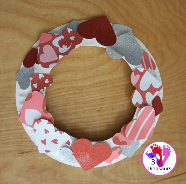 Valentines Heart Wreaths with Scrapbook Paper a fun paper plate wreath made using a heart punch and loads of fun for Valentines Day - 3Dinosaurs.com