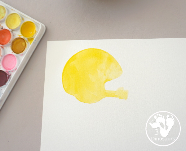 Football Cookie Cutter Watercolor Painting - a fun painting that kids can do with a football theme. A great way to do a fun watercolor painting is by different football team colors. - 3Dinosaurs.com