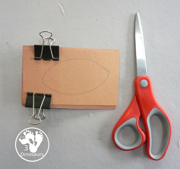 Football Wreath Craft For Kids - a fun wreath craft for a football theme. You have a green wreath with white lines and footballs around the wreath. Great for any football theme. - 3Dinosaurs.com