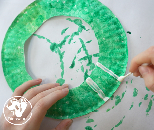 Football Wreath Craft For Kids - a fun wreath craft for a football theme. You have a green wreath with white lines and footballs around the wreath. Great for any football theme. - 3Dinosaurs.com