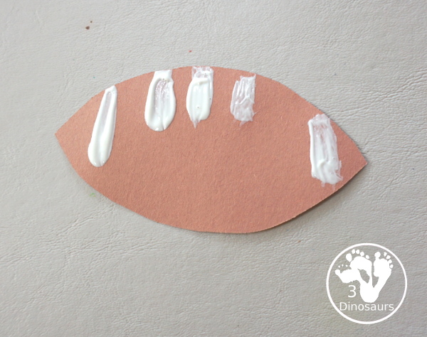 Football Wreath Craft For Kids - a fun wreath craft for a football theme. You have a green wreath with white lines and footballs around the wreath. Great for any football theme. - 3Dinosaurs.com