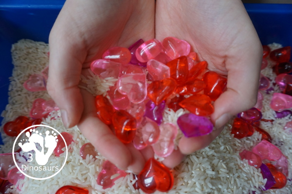 Heart Rice Sensory Bin For Kids - acrylic hearts in a rice sensory bin that you can use with kids during Valentines or a heart shape theme. - 3Dinosaurs.com