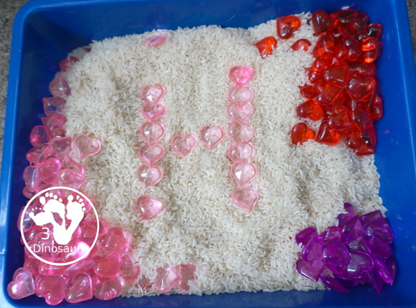 Heart Rice Sensory Bin For Kids - acrylic hearts in a rice sensory bin that you can use with kids during Valentines or a heart shape theme. - 3Dinosaurs.com