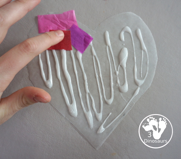 Stained Glass Hearts Craft For Valentine's Day - a simple wax paper craft for kids with tissue paper glue and tissue paper. - 3Dinosaurs.com