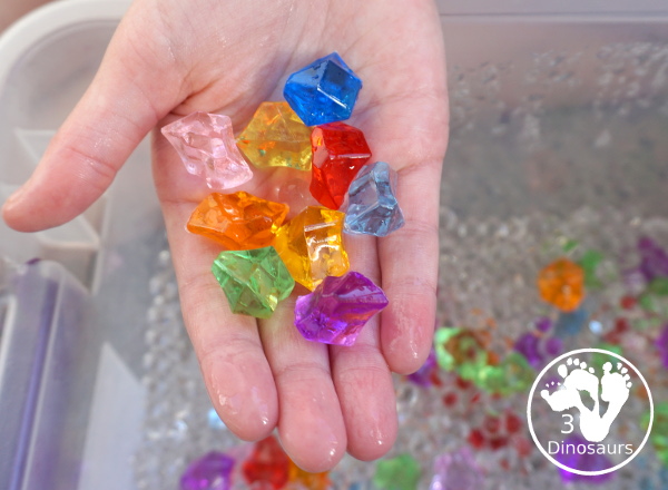Rainbow Colors Water Bead Sensory Bin - a great sensory bin exploring colors through clear waterbeads a fun sensory play for kids to do. - 3Dinosaurs.com