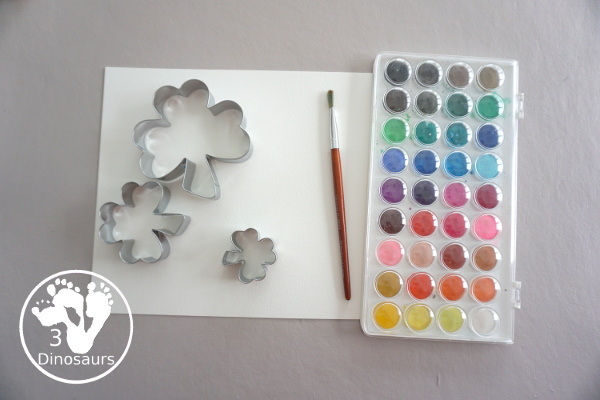 Clover Watercolor Painting for kids - You use watercolor paints, watercolor paper, and clover cookie cutters to make a fun Saint Patrick's Day watercolor painting - 3Dinosaurs.com