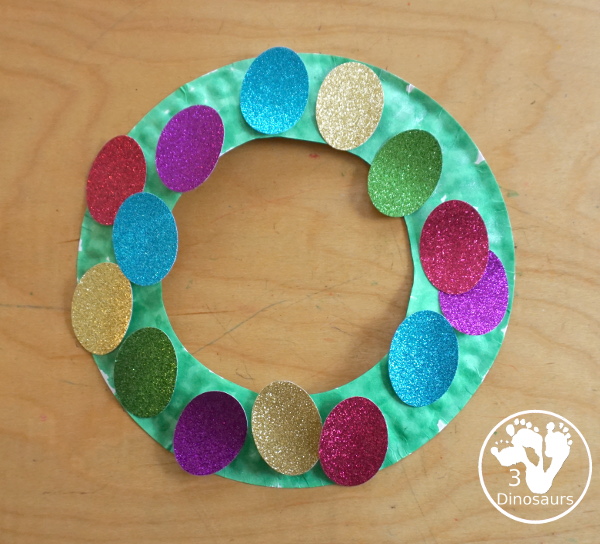 Glitter Easter Egg Wreath Craft - a fun Easter Egg wreath made with a paper plate and ovals for the eggs - 3Dinosaurs.com