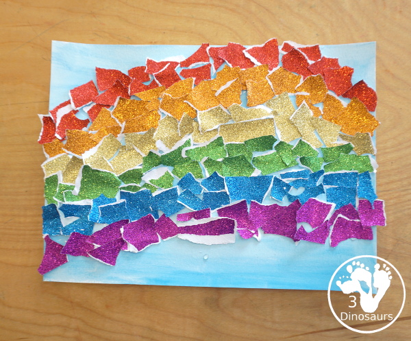 Torn Paper Glitter Rainbow with watercolor Sky Craft - a simple rainbow you can make with torn glitter paper and painting a watercolor background. A simple rainbow for kids prek to first grade - 3Dinosaurs.com