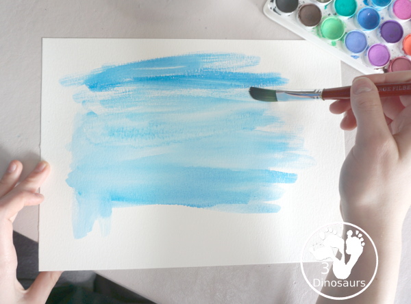 Torn Paper Glitter Rainbow with watercolor Sky Craft - a simple rainbow you can make with torn glitter paper and painting a watercolor background. A simple rainbow for kids prek to first grade - 3Dinosaurs.com