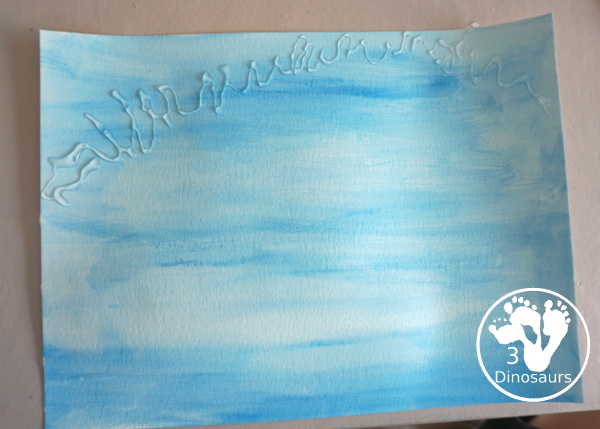 Torn Paper Glitter Rainbow with watercolor Sky Craft - a simple rainbow you can make with torn glitter paper and painting a watercolor background. A simple rainbow for kids prek to first grade - 3Dinosaurs.com