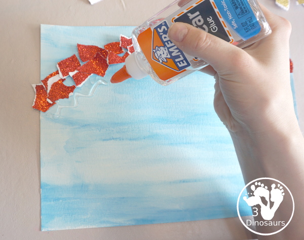 Torn Paper Glitter Rainbow with watercolor Sky Craft - a simple rainbow you can make with torn glitter paper and painting a watercolor background. A simple rainbow for kids prek to first grade - 3Dinosaurs.com