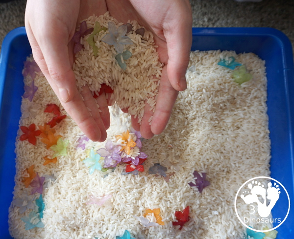 Flower & Rice Sensory Bin - Handfuls of rice and flower and then pour them back in. - 3Dinosaurs.com